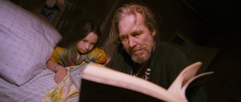 Movie still from “Tideland” (2005), directed by Terry Gilliam – An older man and a young girl looking at a book; Close Up shot, Low angle
