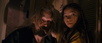 Movie still from “Tideland” (2005), directed by Terry Gilliam – A man and a woman pose for a picture; Close Up shot, Low angle