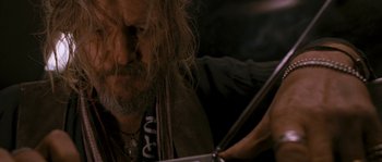 Movie still from “Tideland” (2005), directed by Terry Gilliam – An older man with long white hair and a long beard; Close Up shot, Low angle