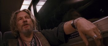 A man sitting in the back seat of a car