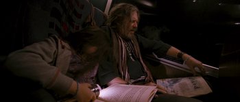 Movie still from “Tideland” (2005), directed by Terry Gilliam – A man sitting on a bus reading a book; Medium shot, High angle