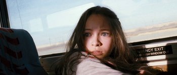 Movie still from “Tideland” (2005), directed by Terry Gilliam – A young girl with blue eyes looking at the camera; Close Up shot, Low angle