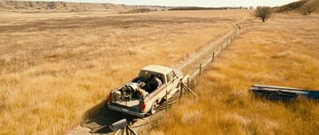 Movie still from “Tideland” (2005), directed by Terry Gilliam – An old pick - up truck is parked in a field; Extreme Wide shot, High angle