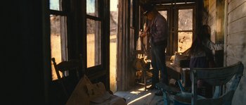Movie still from “Tideland” (2005), directed by Terry Gilliam – A man standing in front of an open window; Wide shot, Low angle