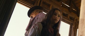 Movie still from “Tideland” (2005), directed by Terry Gilliam – A young girl and a man in a hat; Close Up shot, Low angle