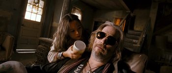 Movie still from “Tideland” (2005), directed by Terry Gilliam – A man with long hair and sunglasses is getting a drink from a cup; Close Up shot, Low angle