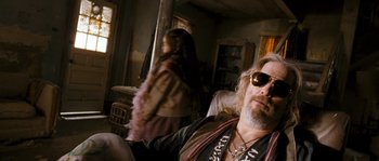 Movie still from “Tideland” (2005), directed by Terry Gilliam – A man and a woman in a living room; Medium shot, Over the shoulder angle