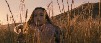 Movie still from “Tideland” (2005), directed by Terry Gilliam – A woman standing in a field of tall grass; Close Up shot, High angle