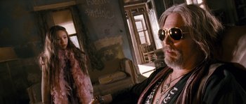 Movie still from “Tideland” (2005), directed by Terry Gilliam – An older man with a beard wearing sunglasses; Close Up shot, Low angle