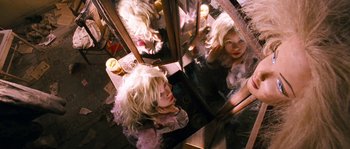 Movie still from “Tideland” (2005), directed by Terry Gilliam – A woman sitting in front of a mirror with long blonde hair; Close Up shot, Overhead angle