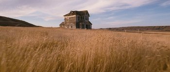 Movie still from “Tideland” (2005), directed by Terry Gilliam – An old house in the middle of a wheat field; Extreme Wide shot, Low angle