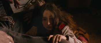 Movie still from “Tideland” (2005), directed by Terry Gilliam – A young girl is laying down on the floor; Close Up shot, High angle