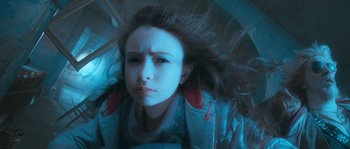 Movie still from “Tideland” (2005), directed by Terry Gilliam – A young girl is laying down with her hair blowing in the wind; Close Up shot, Low angle