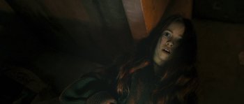 Movie still from “Tideland” (2005), directed by Terry Gilliam – A woman with long red hair is sitting on a bed; Close Up shot, Low angle