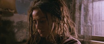 Movie still from “Tideland” (2005), directed by Terry Gilliam – A person with dreadlocks looking down; Close Up shot, Low angle