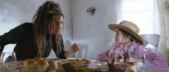 Movie still from “Tideland” (2005), directed by Terry Gilliam – A woman sitting at a table with a child; Medium shot, Over the shoulder angle