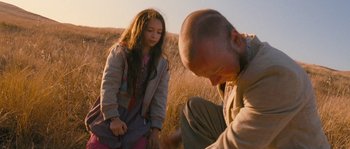 Movie still from “Tideland” (2005), directed by Terry Gilliam – A man and a woman in a field; Medium shot, Over the shoulder angle