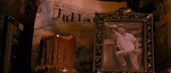 Movie still from “Tideland” (2005), directed by Terry Gilliam – An old photo of a man in a chair in front of a candle; Extreme Close Up shot, High angle