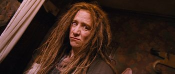 Movie still from “Tideland” (2005), directed by Terry Gilliam – A woman with dreads and a black shirt; Close Up shot, Low angle