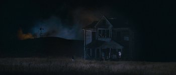 Movie still from “Tideland” (2005), directed by Terry Gilliam – An old abandoned house in a field at night; Extreme Wide shot, High angle