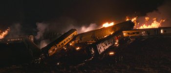 Movie still from “Tideland” (2005), directed by Terry Gilliam – A train that is on fire in the dark; Extreme Wide shot, High angle