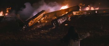 Movie still from “Tideland” (2005), directed by Terry Gilliam – A train that is on a track near some buildings; Extreme Wide shot, High angle