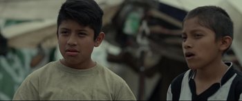 Movie still from “Tigers Are Not Afraid” (2017), directed by Issa López – A young boy is looking at the camera; Close Up shot, Over the shoulder angle