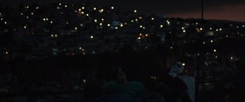 Movie still from “Tigers Are Not Afraid” (2017), directed by Issa López – A night view of a city with lights in the background; Extreme Wide shot, Over the shoulder angle
