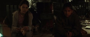 Movie still from “Tigers Are Not Afraid” (2017), directed by Issa López – A couple of people that are sitting in a room; Medium shot, Over the shoulder angle