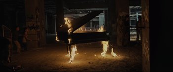 Movie still from “Tigers Are Not Afraid” (2017), directed by Issa López – A piano is burning in the middle of the night; Extreme Wide shot, High angle