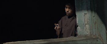 Movie still from “Tigers Are Not Afraid” (2017), directed by Issa López – A young man holding a cigarette in his hand; Medium shot, Low angle