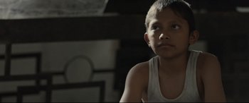 Movie still from “Tigers Are Not Afraid” (2017), directed by Issa López – A young boy is sitting in a room; Close Up shot, Over the shoulder angle