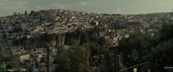 Movie still from “Tigers Are Not Afraid” (2017), directed by Issa López – A view of a city from a hill; Extreme Wide shot, High angle