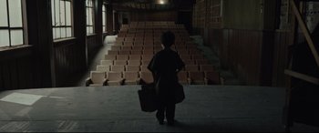 Movie still from “Tigers Are Not Afraid” (2017), directed by Issa López – A person standing in front of an empty auditorium; Extreme Wide shot, High angle