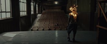Movie still from “Tigers Are Not Afraid” (2017), directed by Issa López – A man walking in front of an empty auditorium; Wide shot, Low angle
