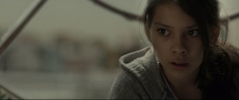 Movie still from “Tigers Are Not Afraid” (2017), directed by Issa López – A young woman is looking into the camera; Close Up shot, Over the shoulder angle