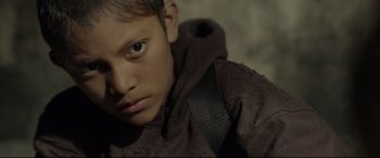 Movie still from “Tigers Are Not Afraid” (2017), directed by Issa López – A person wearing a hooded jacket; Close Up shot, Over the shoulder angle