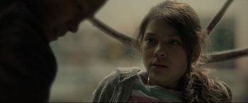 Movie still from “Tigers Are Not Afraid” (2017), directed by Issa López – A young girl is looking into the camera with an adult; Close Up shot, Over the shoulder angle