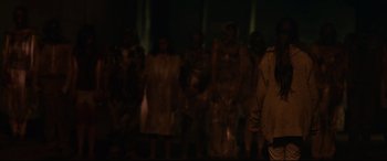 Movie still from “Tigers Are Not Afraid” (2017), directed by Issa López – A group of people standing in the dark; Medium shot, Over the shoulder angle