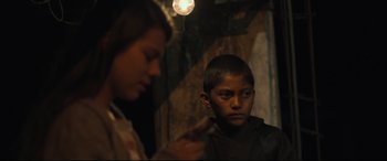 Movie still from “Tigers Are Not Afraid” (2017), directed by Issa López – A young boy and a woman are looking in a mirror; Close Up shot, Over the shoulder angle