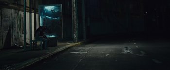 Movie still from “Tigers Are Not Afraid” (2017), directed by Issa López – A dark street with a sign on the side of the road; Wide shot, Low angle