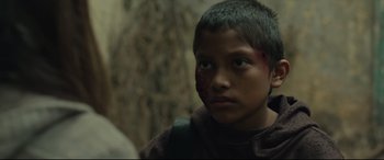 Movie still from “Tigers Are Not Afraid” (2017), directed by Issa López – A young boy with a bandage on his face; Close Up shot, Over the shoulder angle