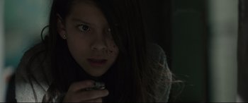 Movie still from “Tigers Are Not Afraid” (2017), directed by Issa López – A young girl is looking into the camera; Close Up shot, High angle