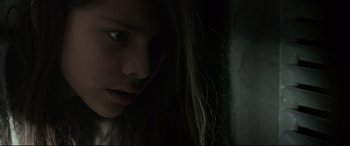 Movie still from “Tigers Are Not Afraid” (2017), directed by Issa López – A young girl with long hair looking down at her face; Close Up shot, Low angle