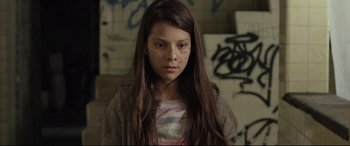 Movie still from “Tigers Are Not Afraid” (2017), directed by Issa López – A young girl is standing in front of a wall; Close Up shot, Low angle