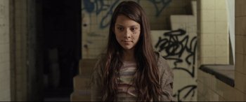 Movie still from “Tigers Are Not Afraid” (2017), directed by Issa López – A young girl with long brown hair sitting in a room; Close Up shot, Low angle