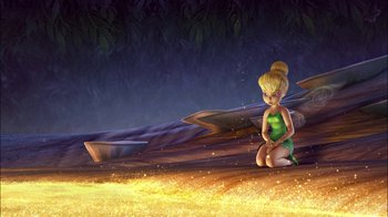 Movie still from “Tinker Bell” (2008), directed by Bradley Raymond – A tinkerbell sitting on the ground in front of a forest; Wide shot, High angle
