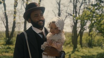 Movie still from “Anne with an E” (2017), created by Moira Walley-Beckett – A man holding a baby in his arms; Medium shot, Over the shoulder angle