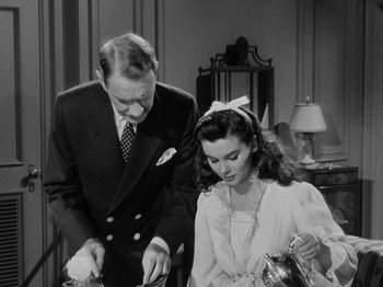 Movie still from “Titanic” (1953), directed by Jean Negulesco – An old photo of a man and a young girl; Medium shot, High angle