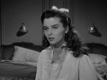 Movie still from “Titanic” (1953), directed by Jean Negulesco – A black - and - white photo of a woman with a bow in her hair; Close Up shot, Over the shoulder angle